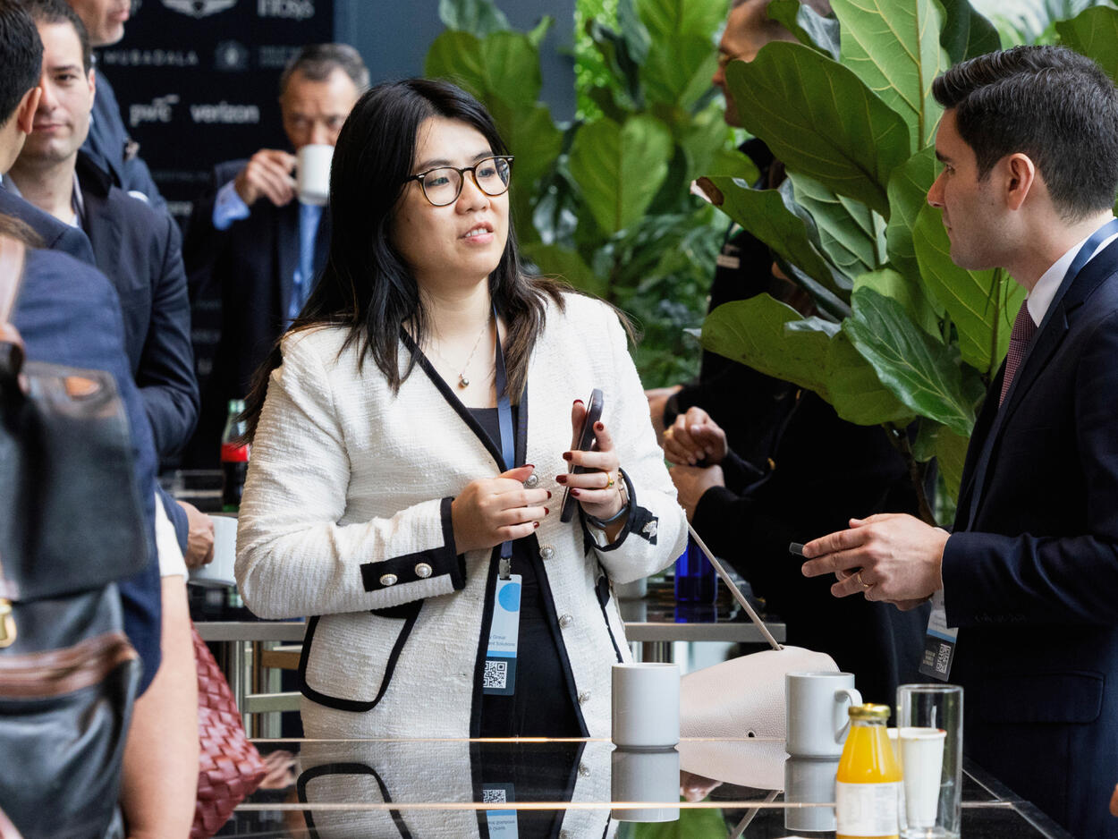 Two attendees in conversation at a Semafor World Economy event